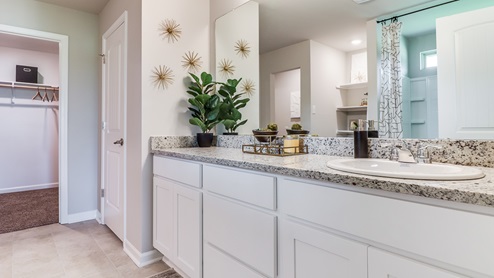 Primary bathroom with granite and tile floors