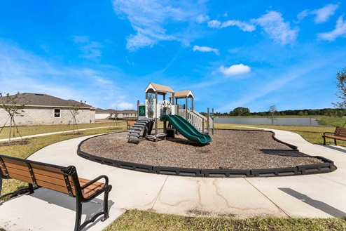 Kids outdoor playground with slide and swings.