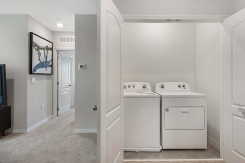 Spacious laundry room with washer and dryer.