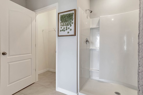 Walk-in shower with private lavatory room.