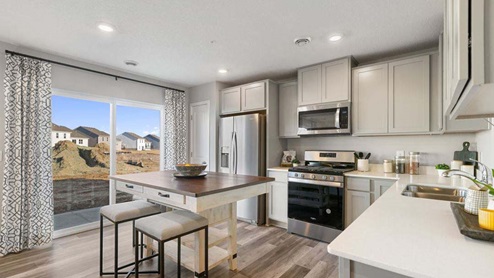 Kitchen with stainless appliances and quartz countertops.